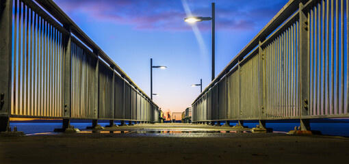 Murrays Bay wharf at dawn. Unrecognizable people fishing on the wharf. North Shore. Auckland.