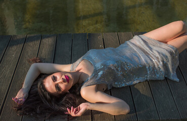 Pretty European Asian woman in sparkle grey dress, fashionable details, mature lady lifestyle