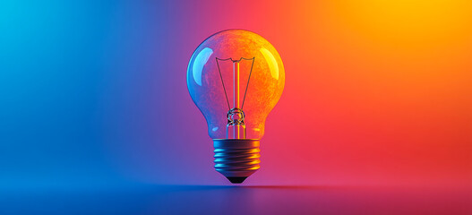 Bright bulb on vibrant backdrop. A glowing light bulb stands alone against a vibrant blue and orange backdrop, creating a striking visual contrast.
