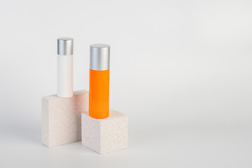 Skin care or sunscreen cosmetic with stylish props on white background.