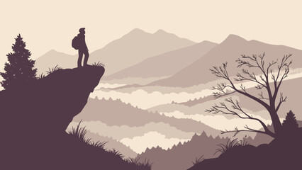 Silhouette of a male hiker standing on a cliff, overlooking a misty valley surrounded by mountains.