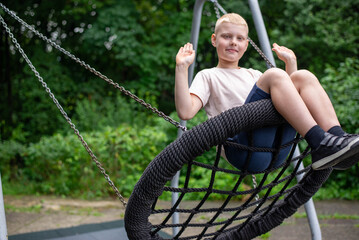 Smiling boy on swing - real-life emotion in the park.