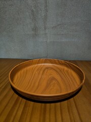 a wooden plate on a wooden pattern table