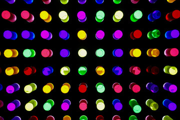 Backlit plexiglass cylinders in various colors, used by small children to create shapes on panels