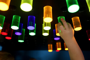 Backlit plexiglass cylinders in various colors, used by small children to create shapes on panels