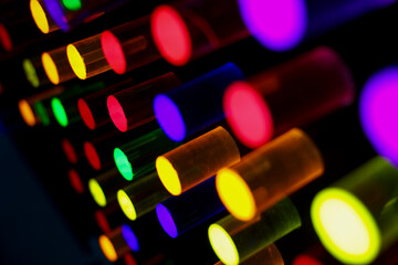 Backlit plexiglass cylinders in various colors, used by small children to create shapes on panels