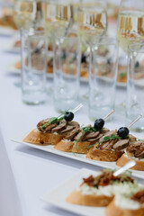 Delicious finger food with wine glasses