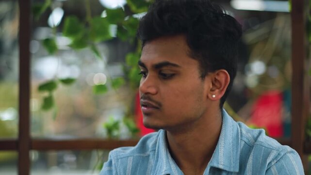 Indian man leaning toward friend with expressive face and hand gesture asking why friend is not eating, calm indoor setting with soft light, focus on concerned interaction and emotional connection
