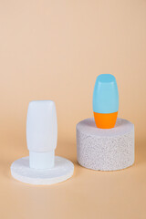 Cosmetic product in tube, bottle, lotion or serum with stylish props on cream background. 