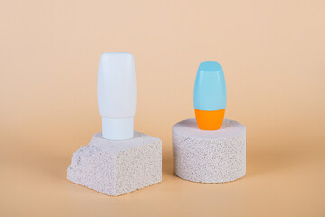 Cosmetic product in tube, bottle, lotion or serum with stylish props on cream background. 
