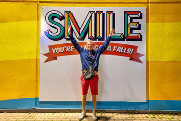A caucasian man on holiday at Niagara Falls at night