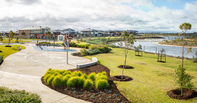 Lakeside public park with basketball court, walking paths and landscaped greenery in suburban residential neighborhood of Melbourne, Australia. Concept of community recreation, outdoor sports - Powered by Adobe