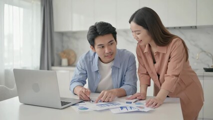 Couple collaborating on project with laptop and financial reports, planning future success together - Powered by Adobe