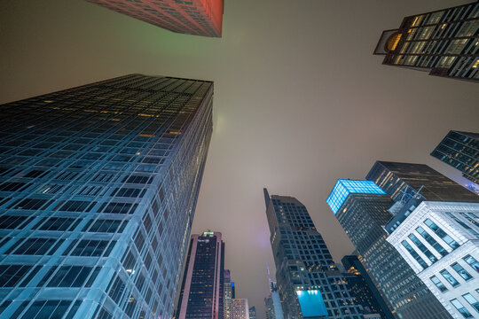 Fototapeta Skyscrapers of Midtown Manhattan in the Broadway area at night seen from a rooftop with city lights