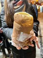 Woman holding traditional Hungarian chimney cake in Budapest