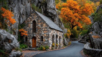 Autumnal stone chapel nestled in rocky gorge