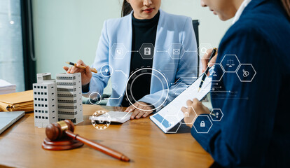 Female lawyer and client discuss legal contract with digital finance icons. Modern law, real...