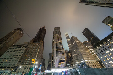 New York City, NY - June 14, 2025: 59th Street in Manhattan at night showcasing glowing facades and bustling city atmosphere