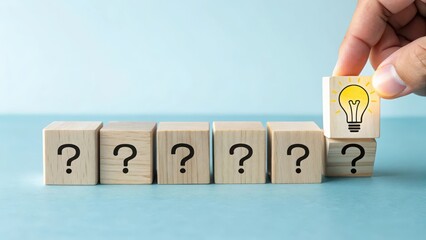 Business solution concept, idea generation and problem solving with lightbulb and question mark blocks