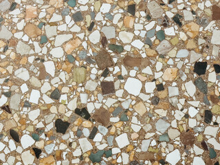 Vintage terrazzo flooring with multicolored marble chips and brown base, classic Italian-style old...