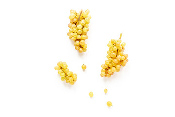 Many bunches of ripe yellow grapes on white background, top view
