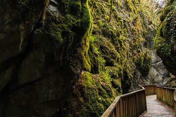 a pedestrian wooden bridge in the canyon and cliffs near it, the rocky mountains, Turkey