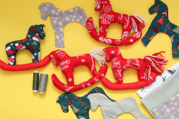 Hand-sewn cotton horses. Christmas tree toy made of fabric. Horse as a symbol of 2026.