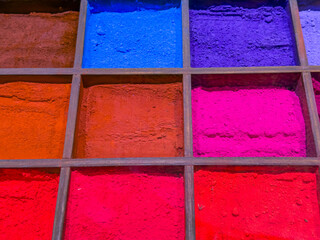 Colorful powder texture background with vivid pigments in square grid layout, abstract artistic...