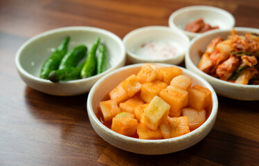 Spicy Korean Radish Kimchi in a Black Bowl
