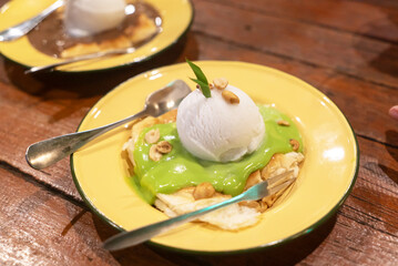 Delicious dessert with ice cream and sauce
