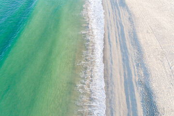 A beautiful sandy shoreline seen from a drone, a perfect summer day
