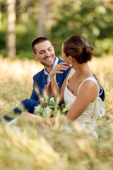 Bride and Groom Sharing a Joyful Moment in Nature During Wedding Day