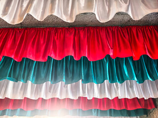 Colorful fabric drapes create festive atmosphere for celebration in decorative setting