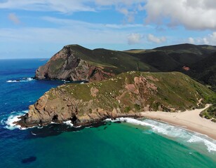 Coastal landscape with dramatic cliffs and a secluded beach