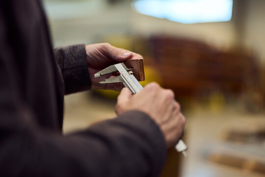 Close-Up of Hands Using Vernier Caliper in Workshop for Measurement - Powered by Adobe
