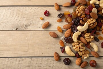Assorted Nuts and Dried Fruits on Wooden Table with Natural Light and Textured Background