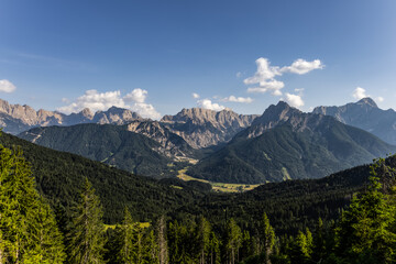 scenic panoramic view of alpine landscape with mountain range under clear blue sky with copy space. summer in the mountains