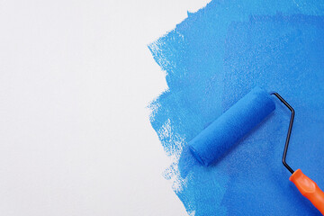 Roller Brush Painting, Worker painting on surface wall Painting apartment, renovating with blue...