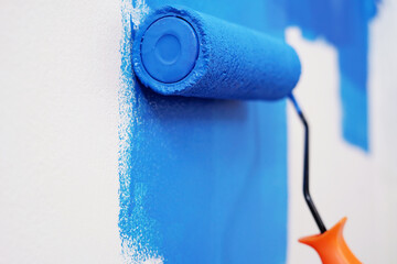 Roller Brush Painting, Worker painting on surface wall Painting apartment, renovating with blue...