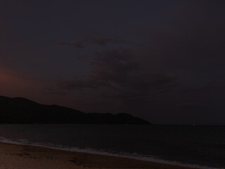 Evening Ocean View with Silhouette of Distant Island

