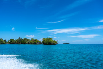 Islet surrounded by blue water, Togian Islands, Sulawesi, Indonesia