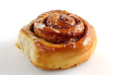 Freshly baked cinnamon roll with glossy glaze, isolated on white. Great for bakery ads, food packaging or sweet breakfast concepts.