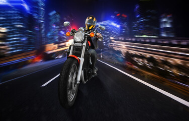 A man is riding a motorcycle down a city street