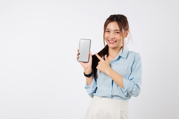 A happy Asian woman holding a mobile phone in her hand, pointing to the blank screen. She is excited, showing the smart phone display. isolated studio white background