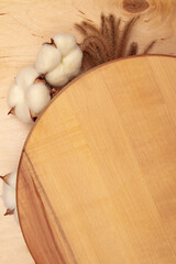 Fluffy decorative spikelets and cotton flowers on wooden background with copy space. Greeting card with Organic beauty showcased on wooden board.