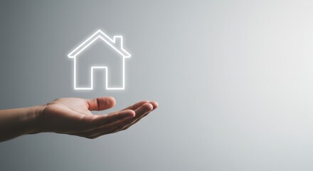 A hand holding a glowing, neon house icon, representing real estate technology and smart home concepts