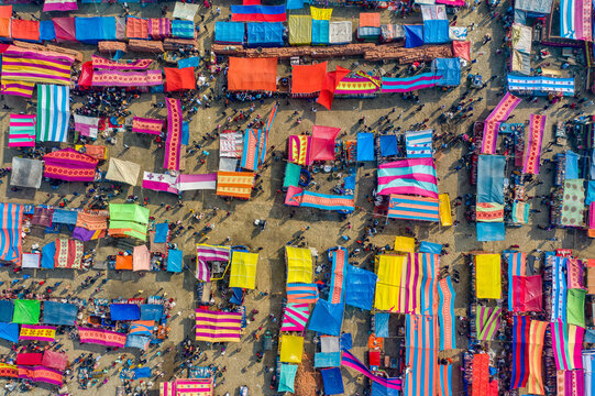 Bogura, Bangladesh - 09 February 2022: Aerial view of a vibrant market, a kaleidoscope of colorful tarps and textiles where the hustle of commerce meets the art of display.