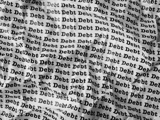 Words Debt Seamless print on crumpled paper for business background.