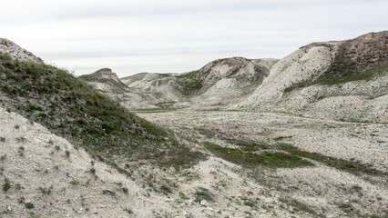 Pokrovsky Cretaceous mountains. Expansive arid landscape features rolling hills and sparse vegetation, showcasing the beauty of natural terrain in a serene and tranquil environment