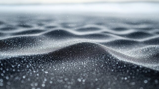 Wavy, textured surface covered in subtle silver sparkles in shallow depth of field